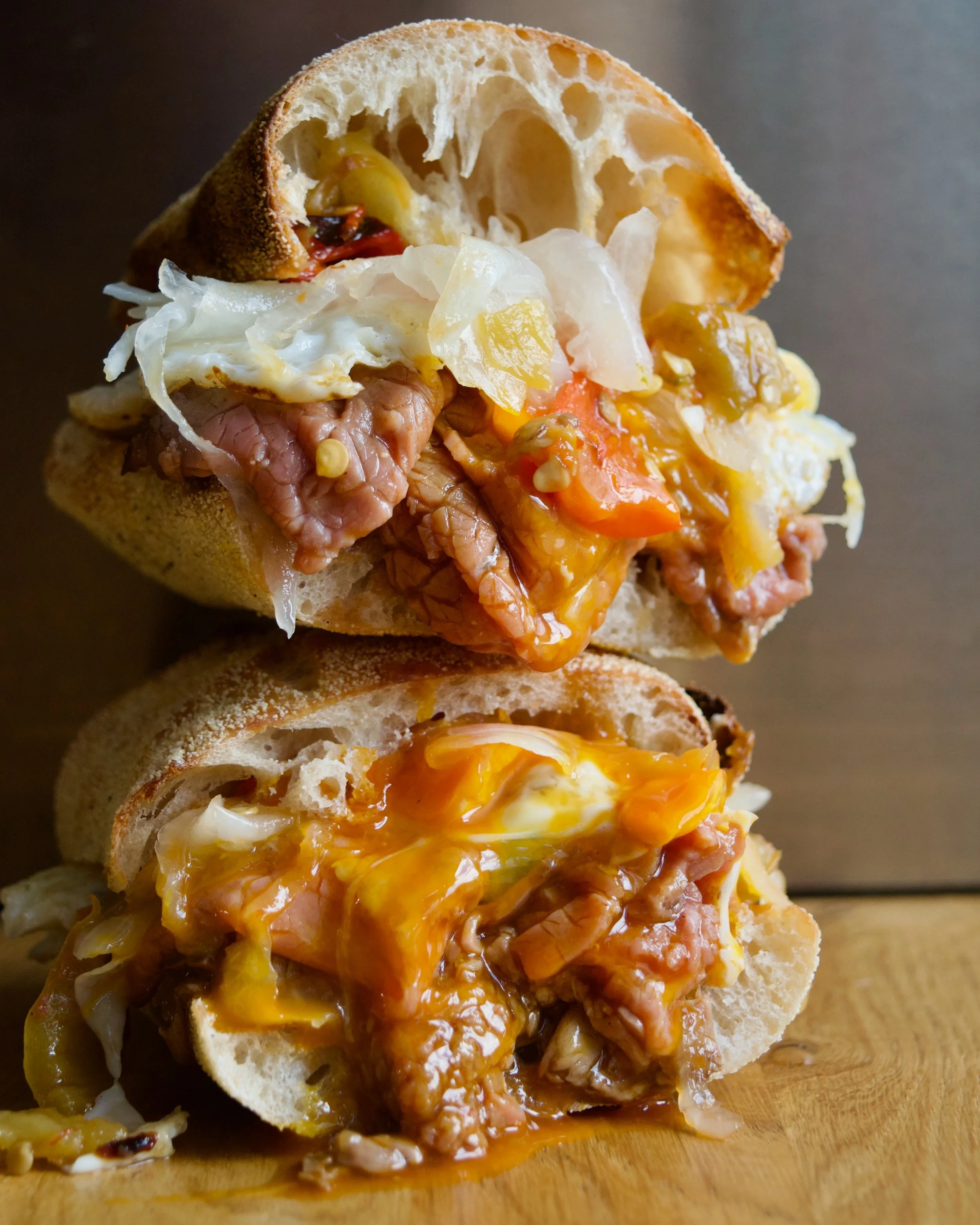 Steak &amp; Eggs 
BREAKFAST SPECIAL!!! 
Not technically steak, but a very macho sandwich nonetheless. 
110g of rare roasted beef topside, sliced wafer thin and dipped in beef sauce. Two fried free-range St Ewe eggs, three slices of proper smoked Brit