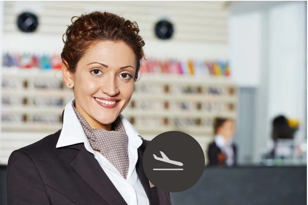 A smiling Altura airport concierge in a dark blazer and patterned scarf, with an aircraft arrival icon