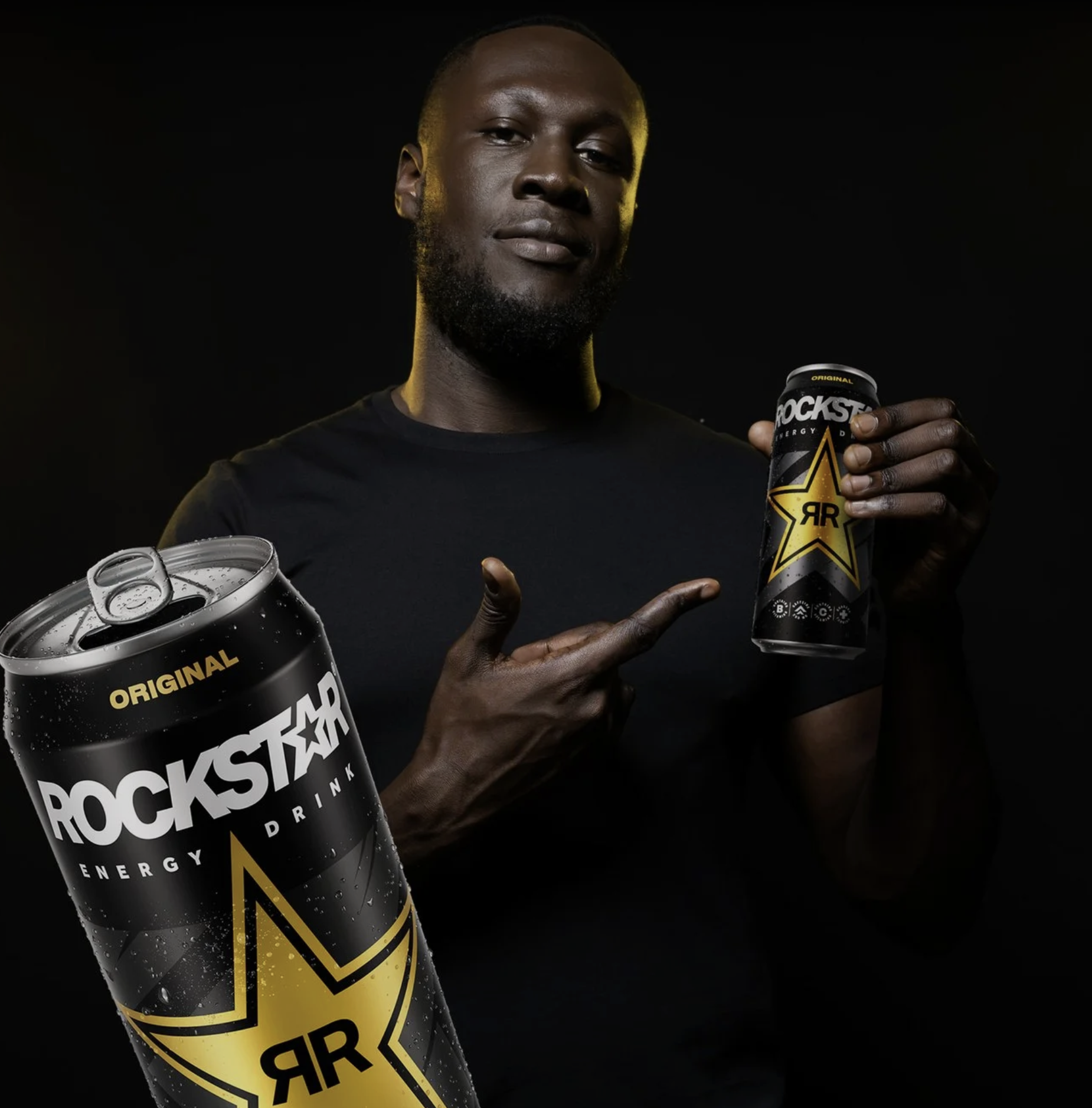 Stormzy with a can of Rockstar on a black background. Graphic Designer Creative Lead.