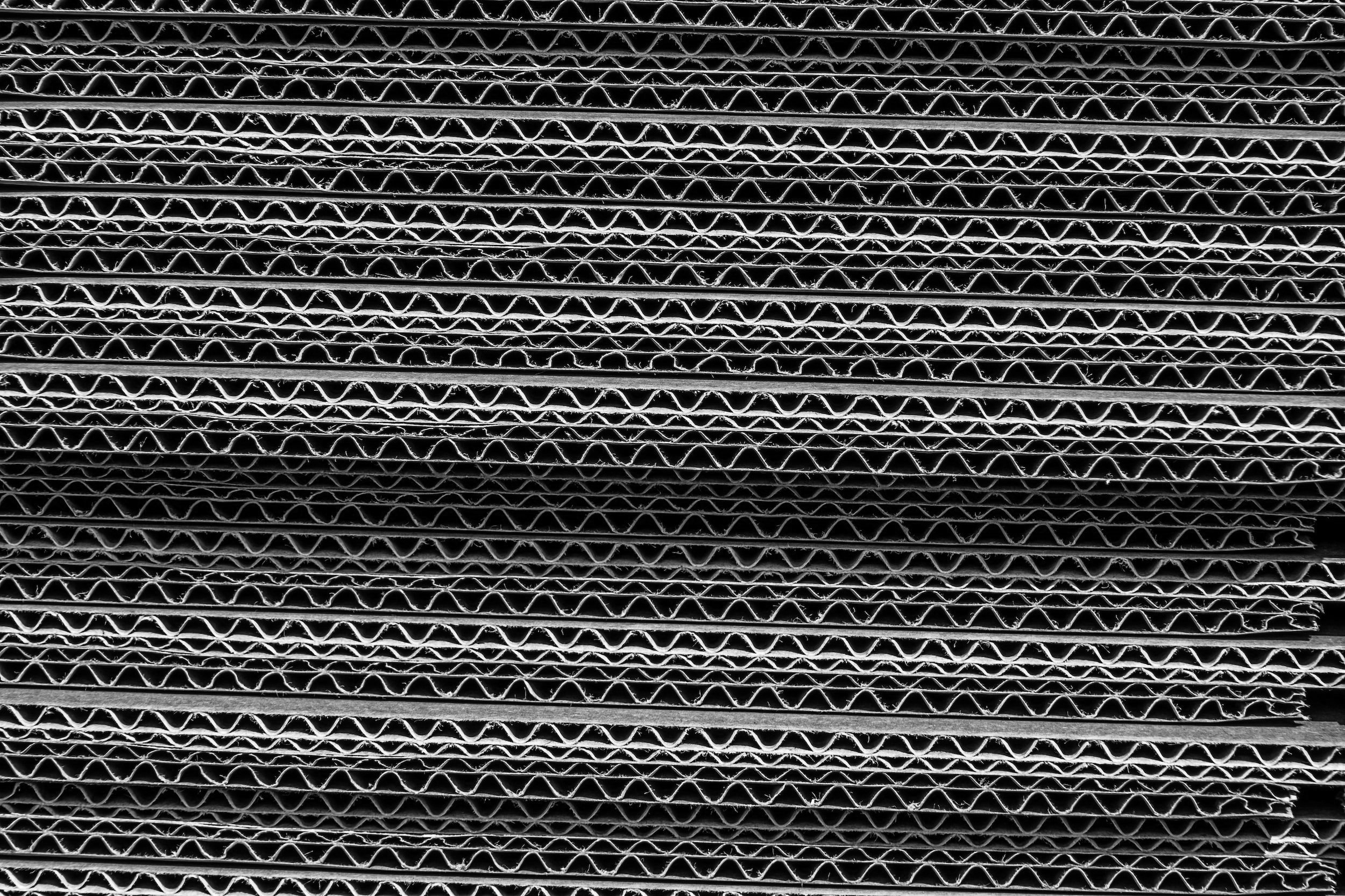 A stack of corrugated boxes in black and white.