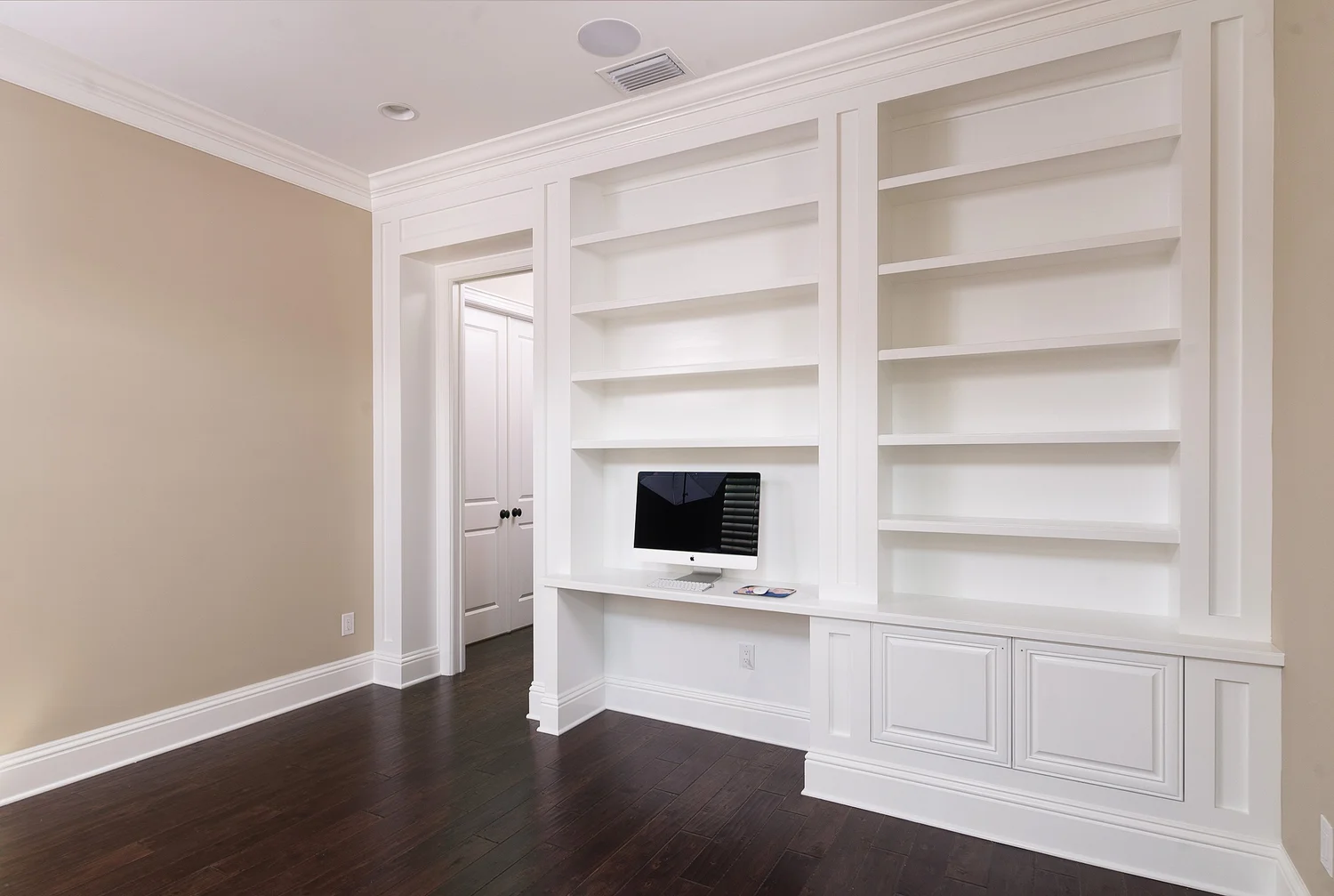 White built-in shelving and fireplace surround