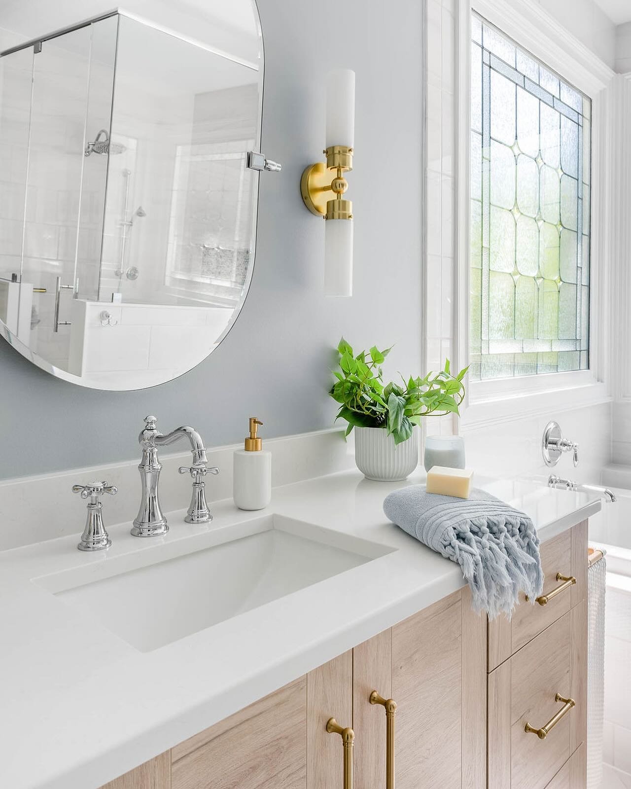 We contrasted this beautiful dolomite tiled wall with @sherwinwilliams Mineral, a gray blue paint, for subtle coastal vibes in this primary bath. 

📸 @sma.photography.nc 
🛠️ @wakeremodeling 
.
.
.
.
.
.
.
@serenaandlily @rejuvenation @moeninc #moen