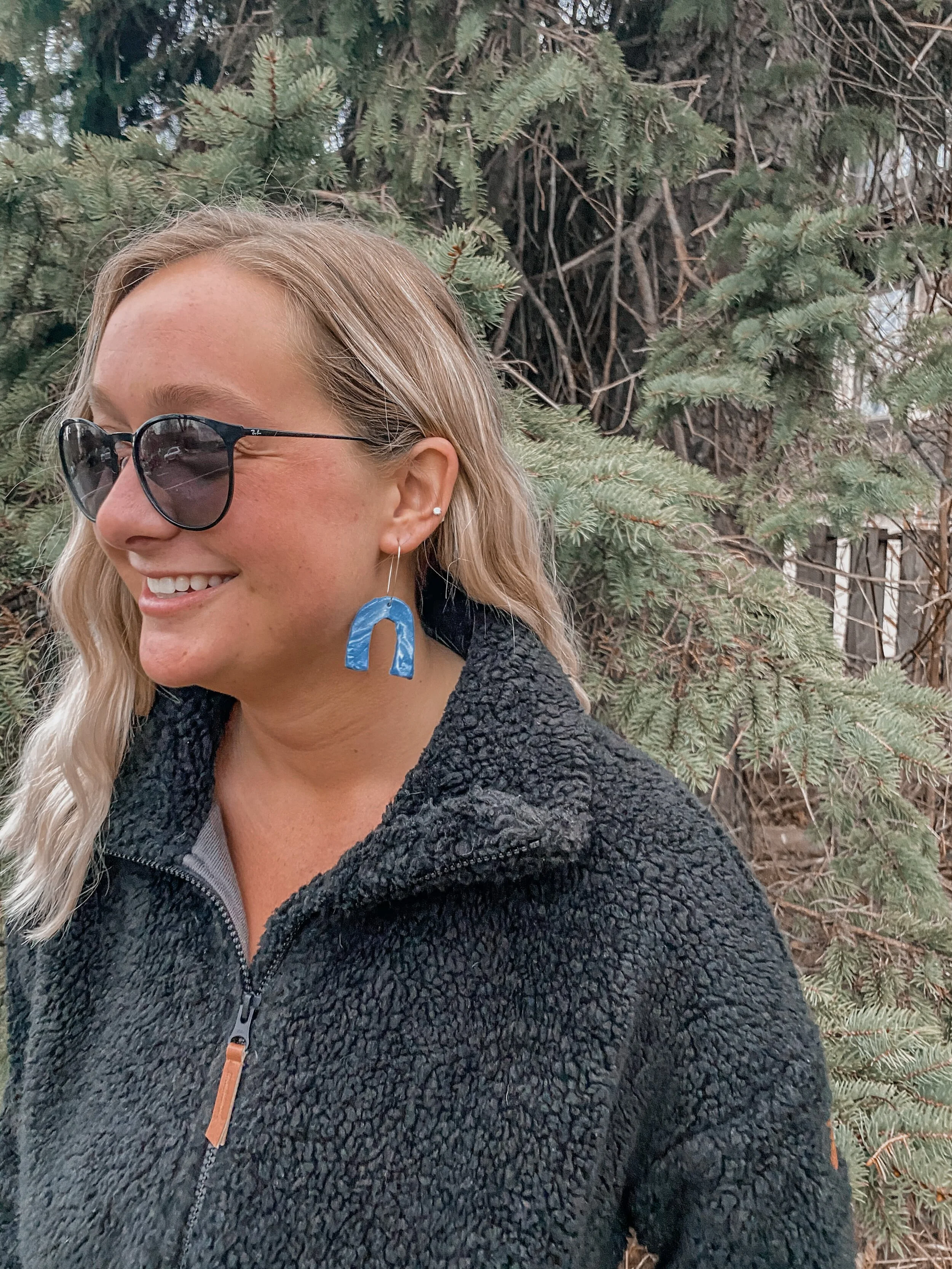 Molly’s roommate modeling earrings. These earrings are marbled. The easiest way to create this look is by rolling out 2-3 colors into long worms. Then you will roll and twist them together into one.