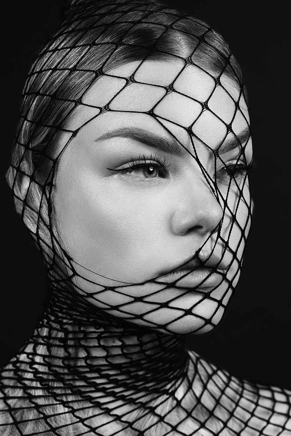 woman in fishnet stocking black and white