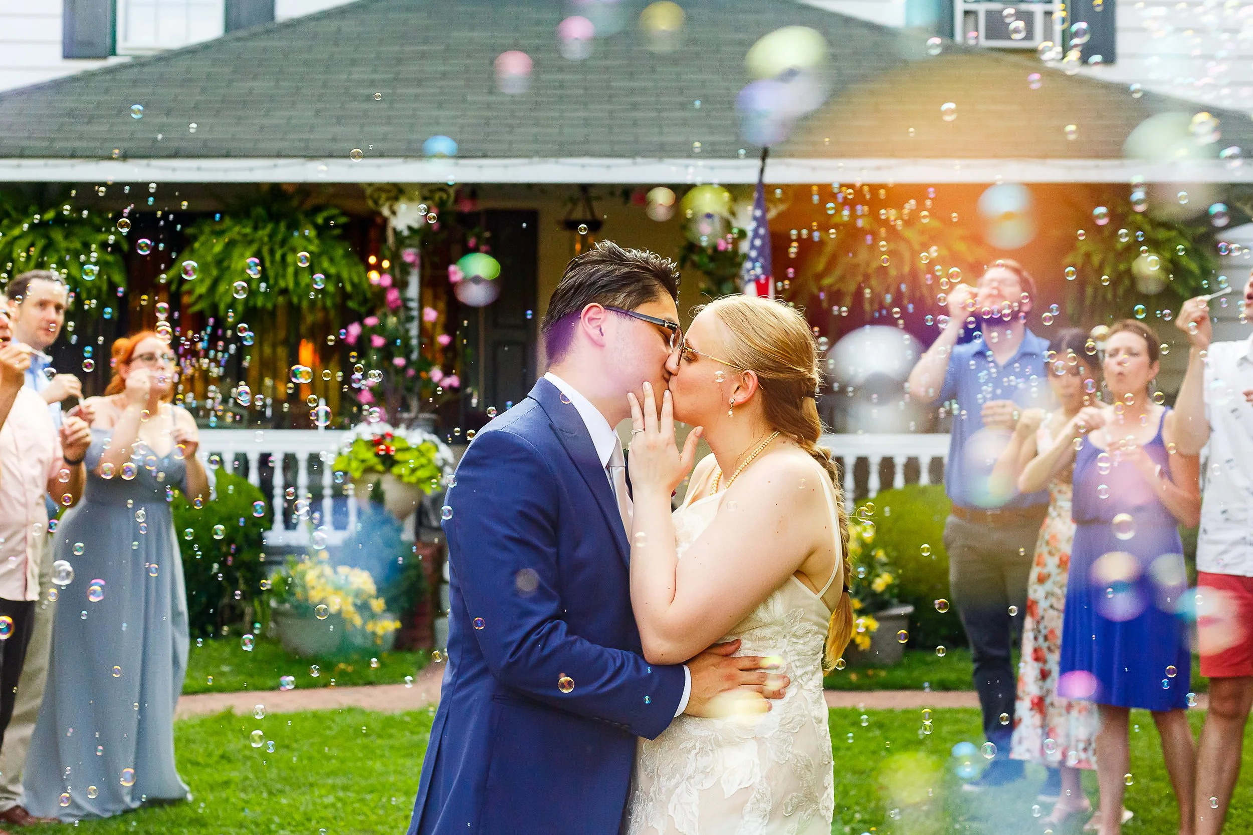 bride and groom kissing during bubble send off