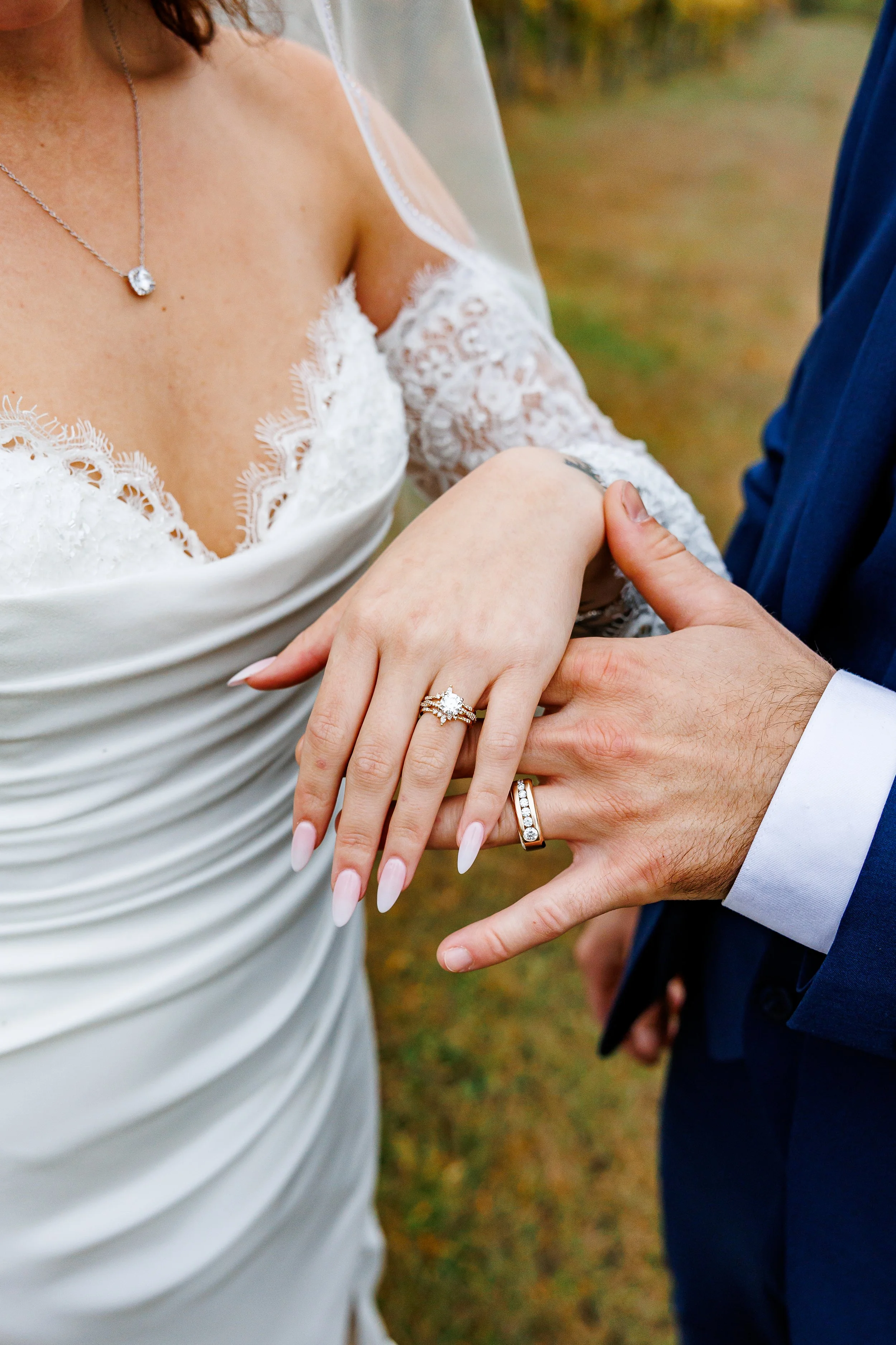 bride and groom show off rings