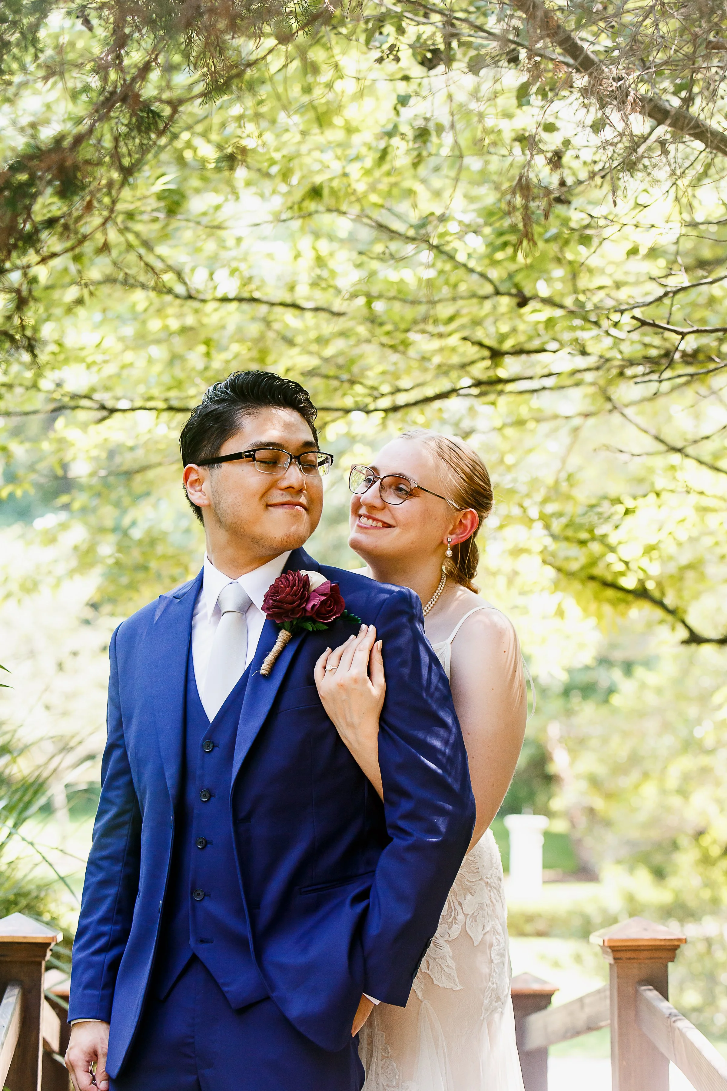 bride hugs groom from behind