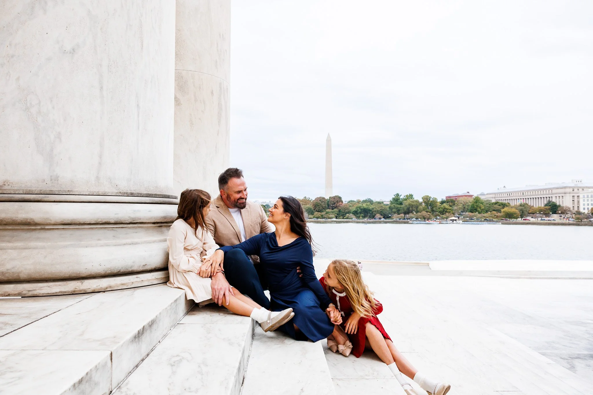 young family laughing playfully at the jefferson memorial in dc