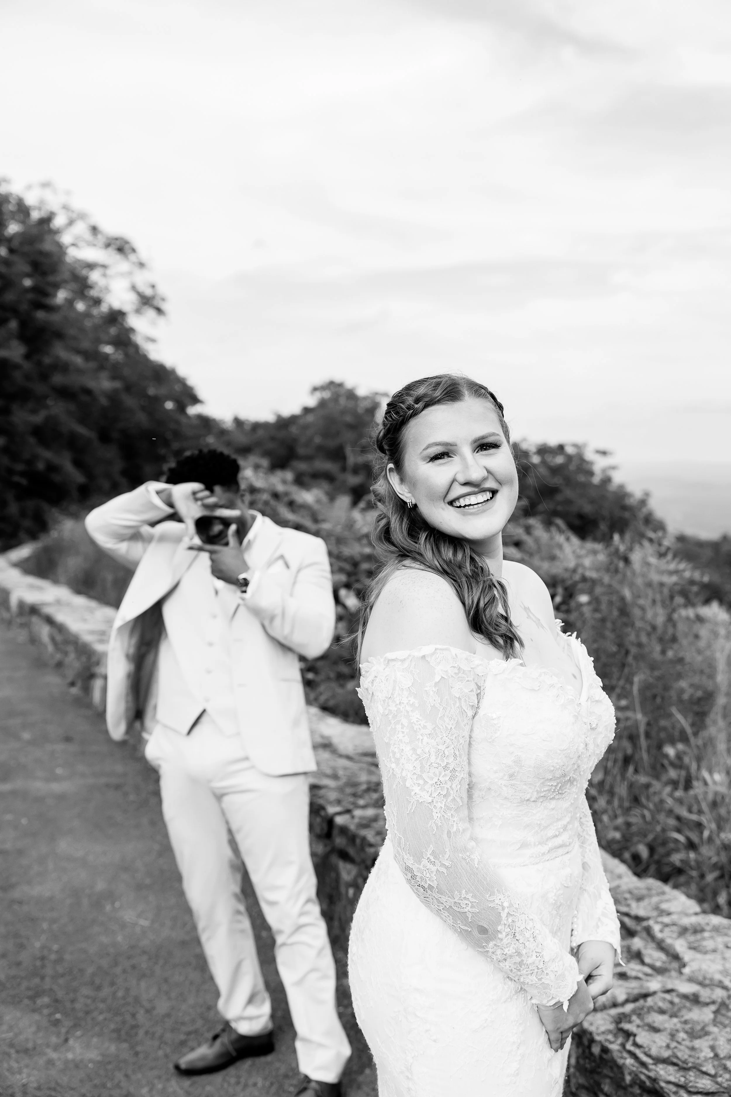 groom pretend taking picture of smiling bride