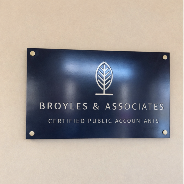 Sign for Broyles & Associates, Certified Public Accountants, mounted on a beige wall.