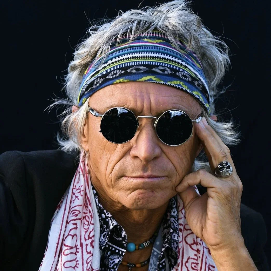 Keith Richards lookalike posing in signature bandana and sunglasses