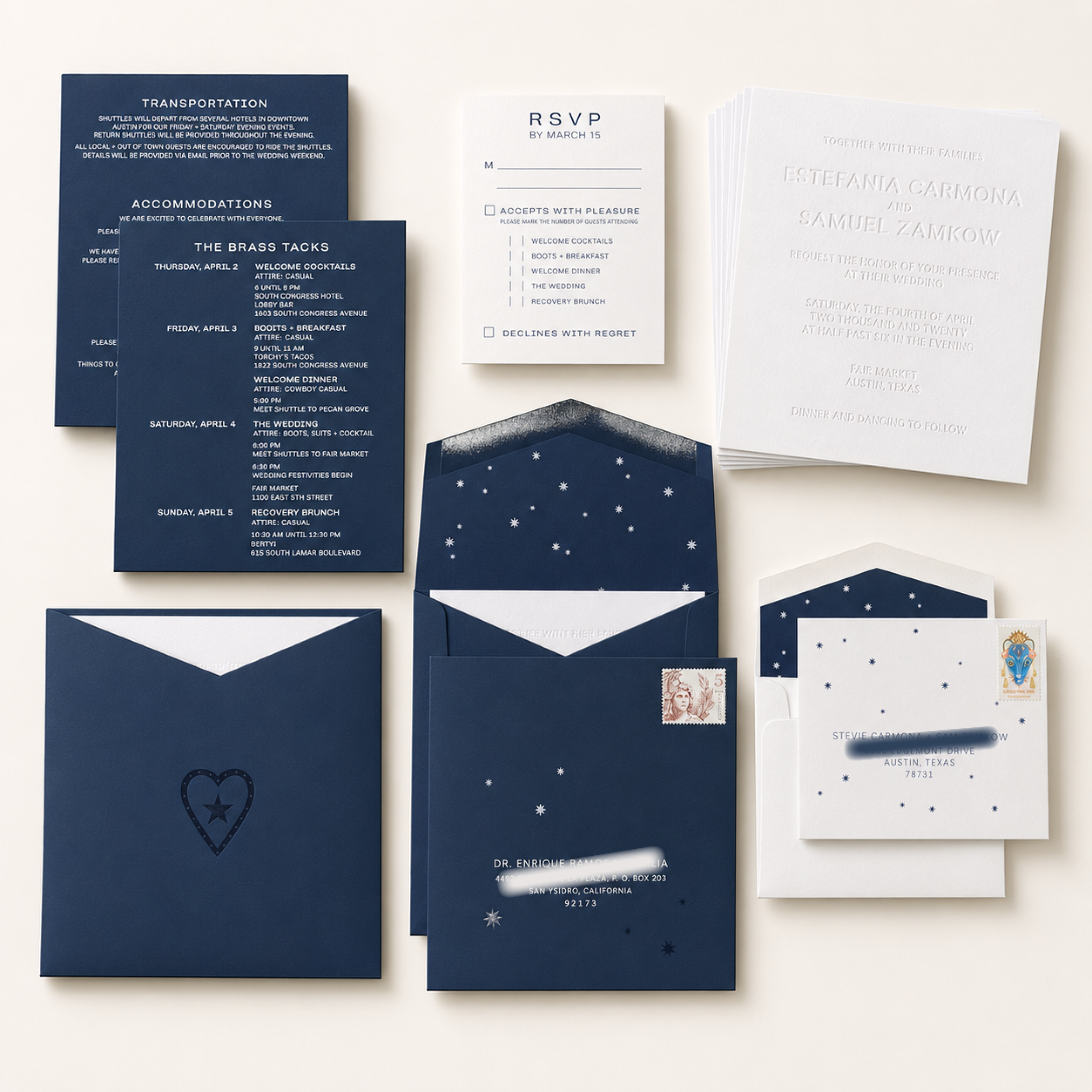 A collection of formal wedding invitations and RSVP cards, with dark blue and white color schemes decorated with snowflake patterns, and some with visible postage stamps.
