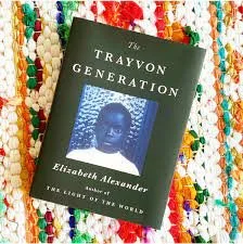 Close-up of a book titled 'The Trayvon Generation' by Elizabeth Alexander, placed on a colorful beaded surface.