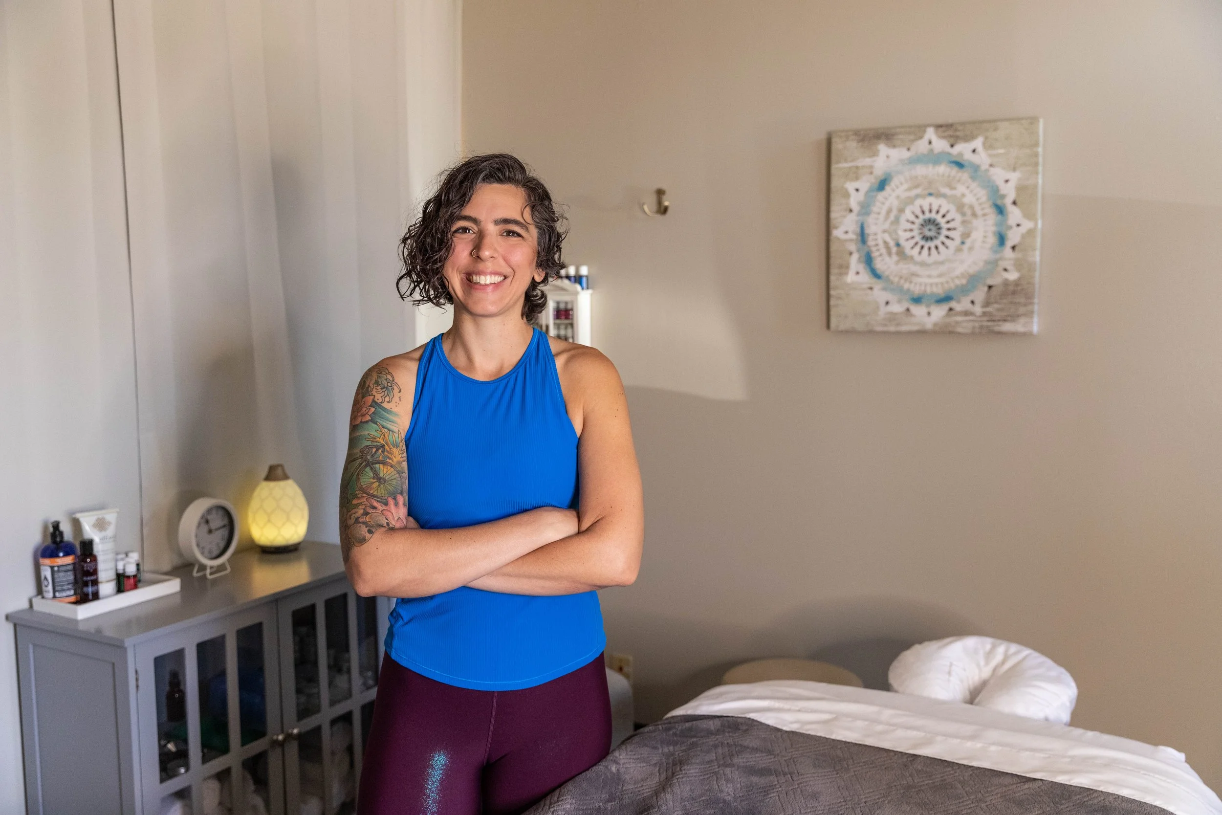 Massage therapist standing next to massage table
