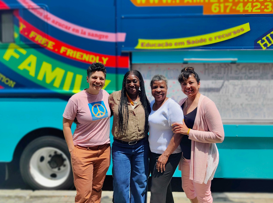 family van staff in front of mobile health vehichle