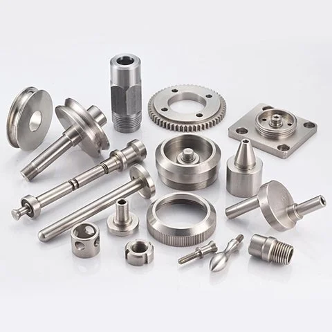 Assorted metal CNC machined parts on a surface.