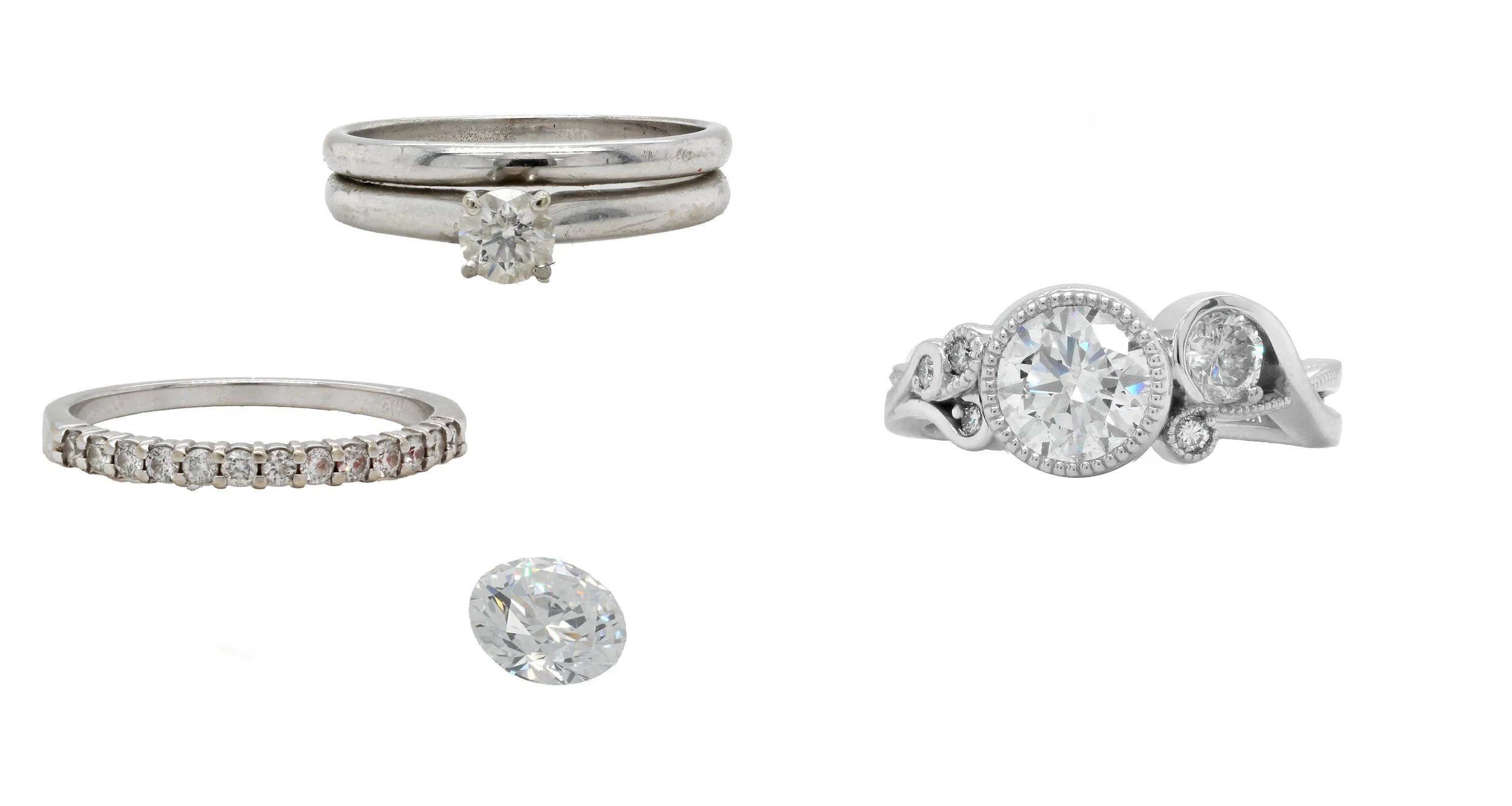 A classic wedding set and diamond band were reimagined into a whimsical, organic design with a soft vintage spirit. Using the original diamonds, we created a flowing composition that centers the primary diamond within a delicate milgrain bezel, while