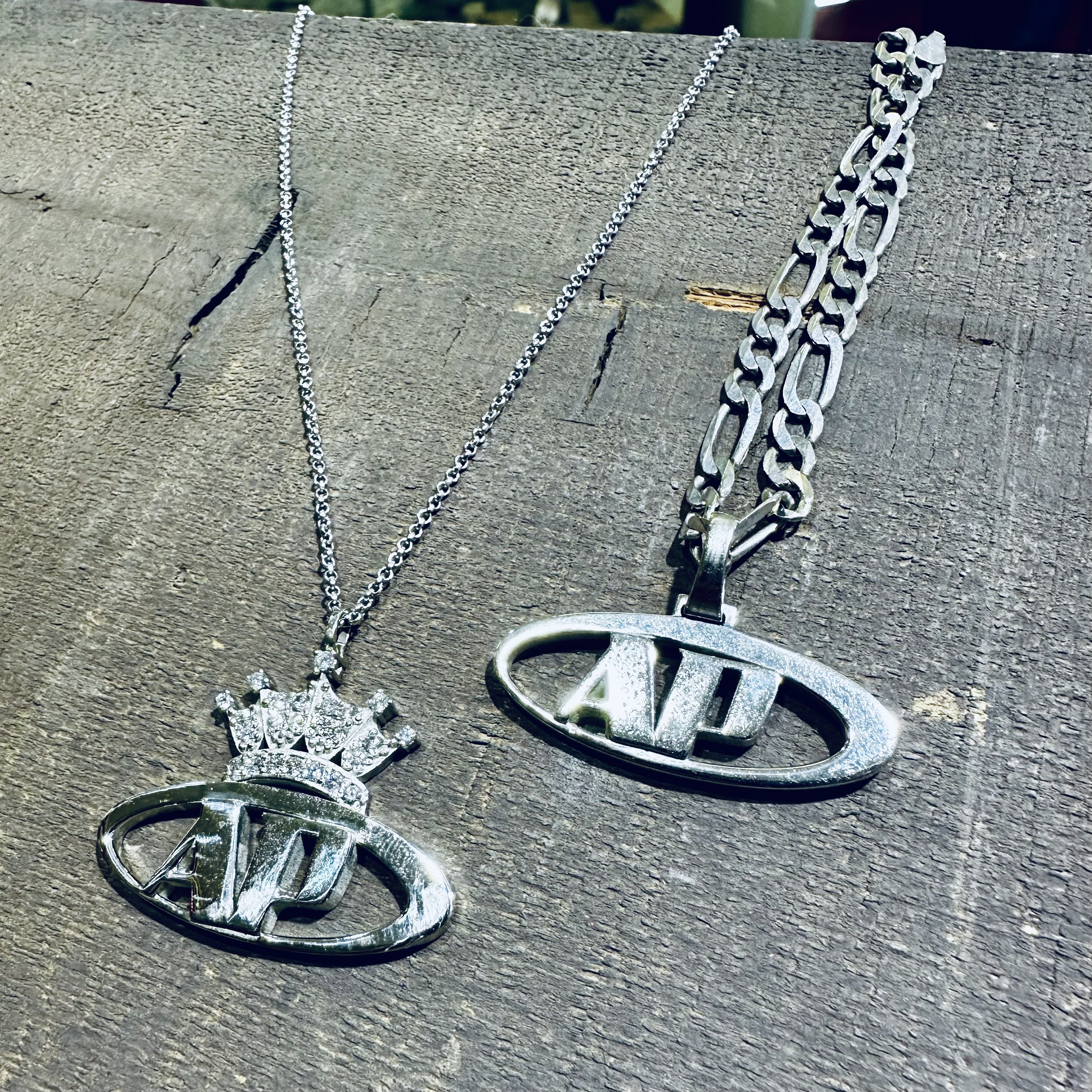 His and hers custom pendants using 14 karat white gold and diamonds.