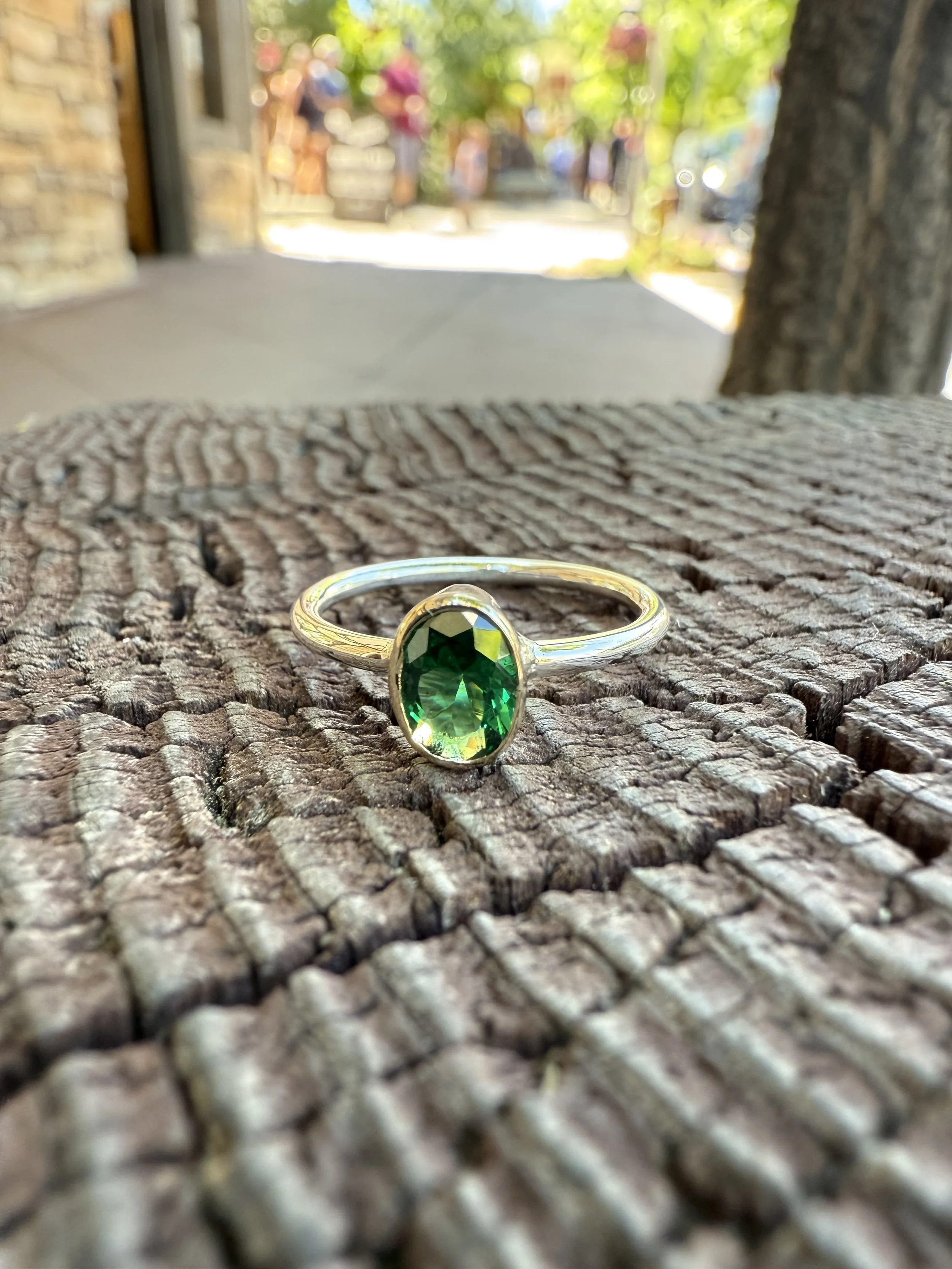 Yellow gold hand crafted solitaire ring including natural tourmaline and 14 karat yellow gold.