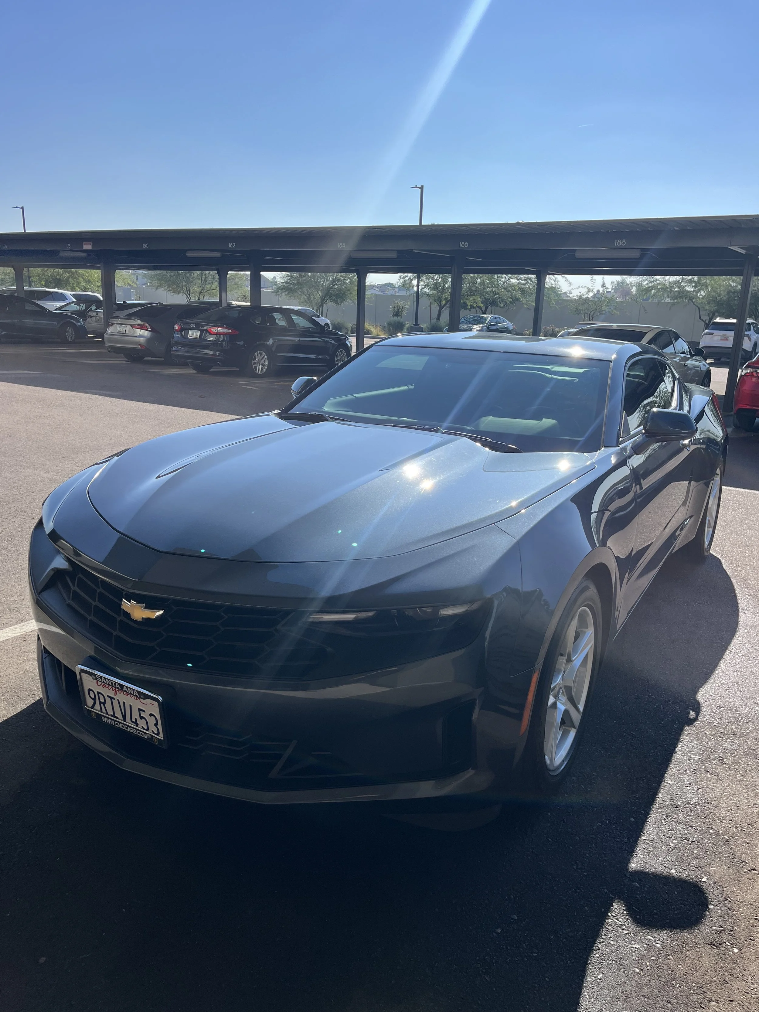 A gray Chevy Camaro parked in apartment parking lot in Phoenix, AZ after paint correction