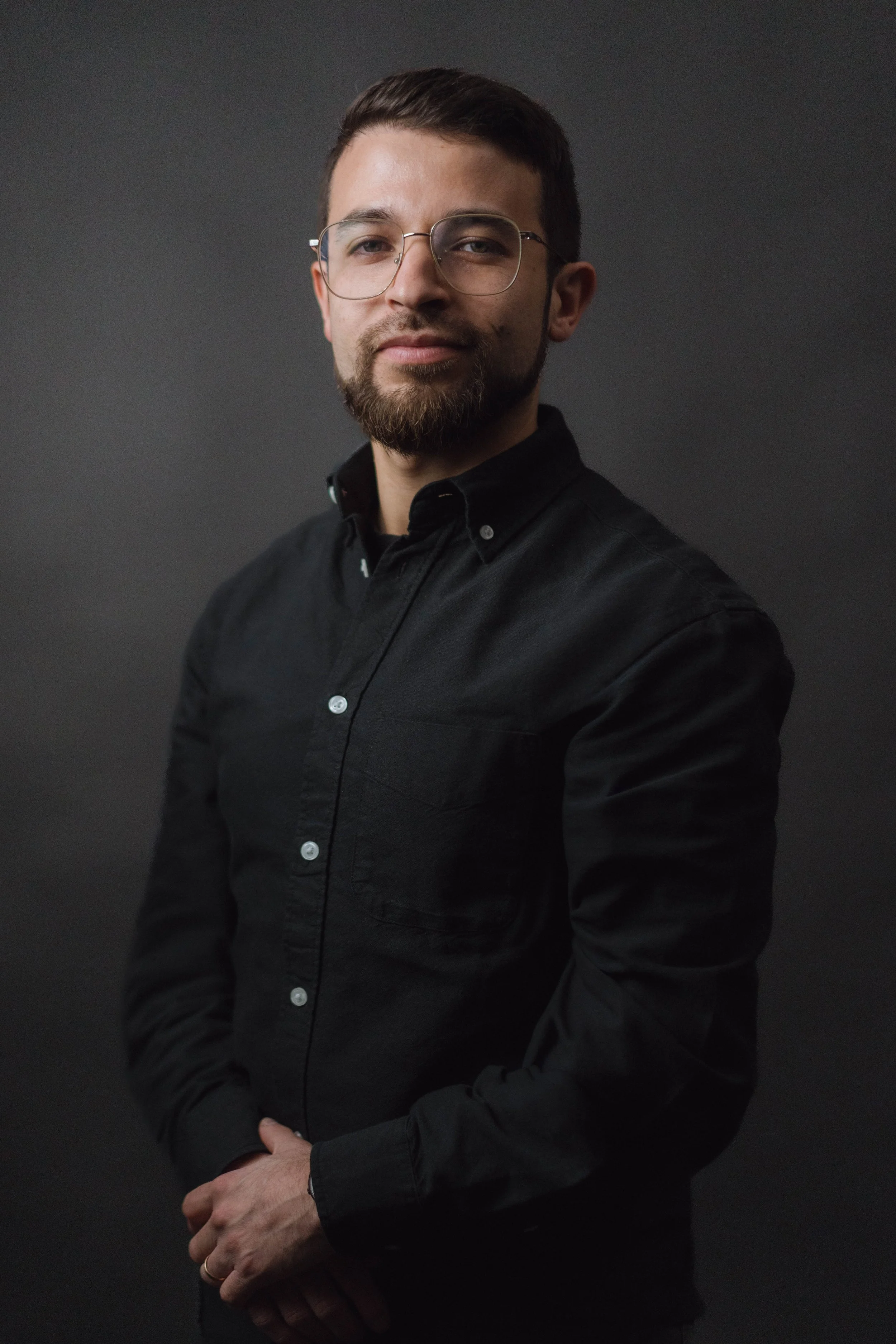 Man with glasses posing for a headshot