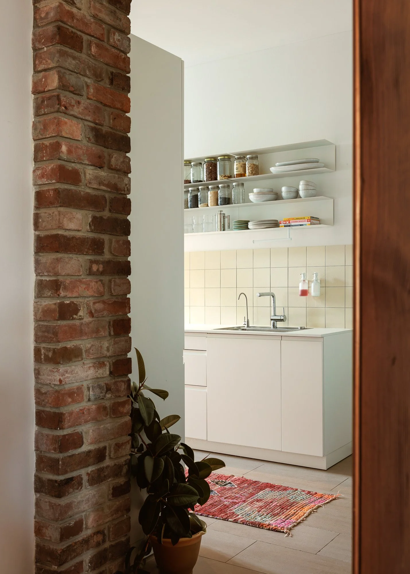 Detail shot of custom handleless kitchen cabinetry with stone countertops and high-end matte finishes, captured by Alessandra Brescia Photography for interior design and architectural photography