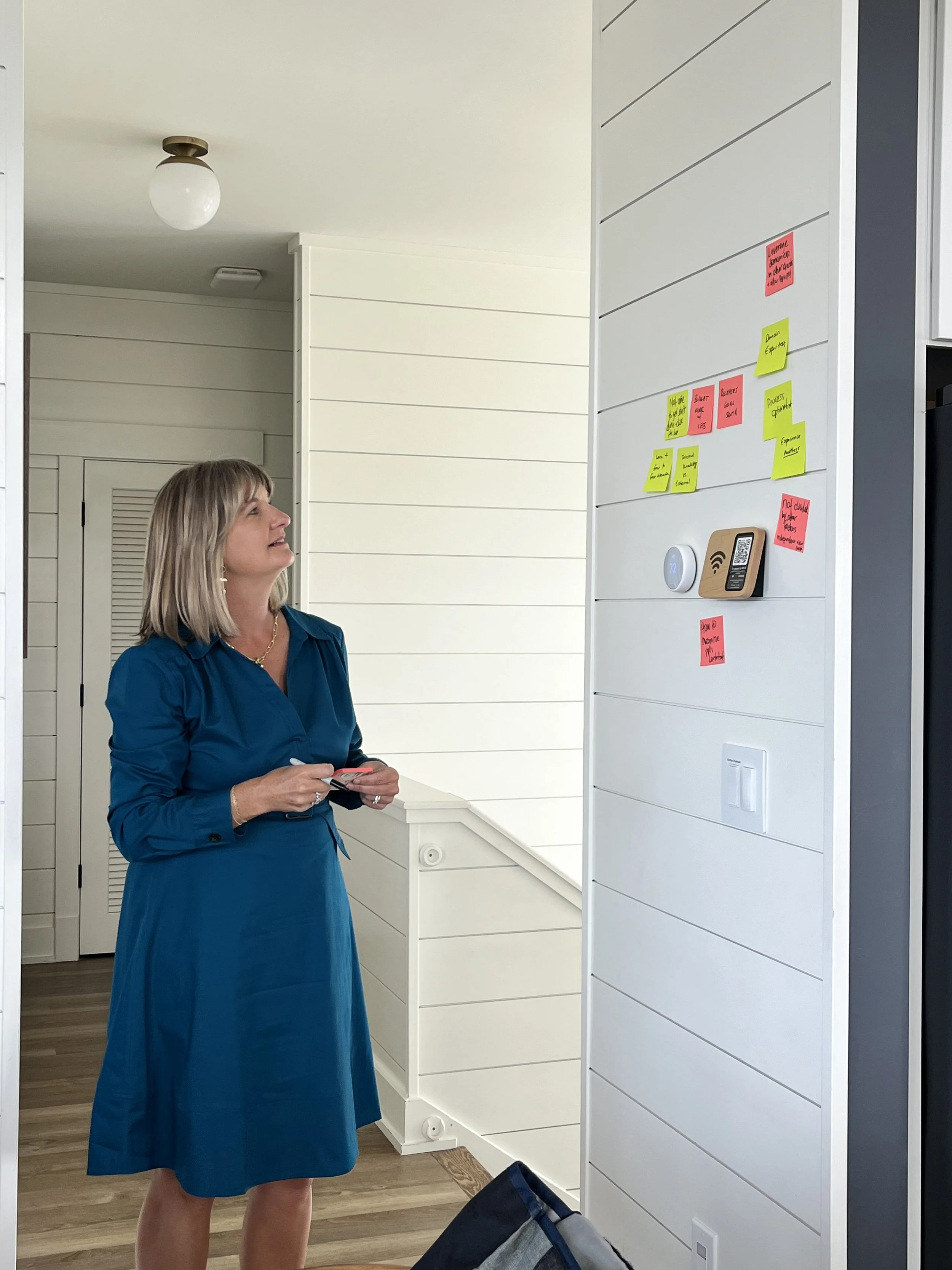 Shelley adding stickies to our brainstorming discussion.