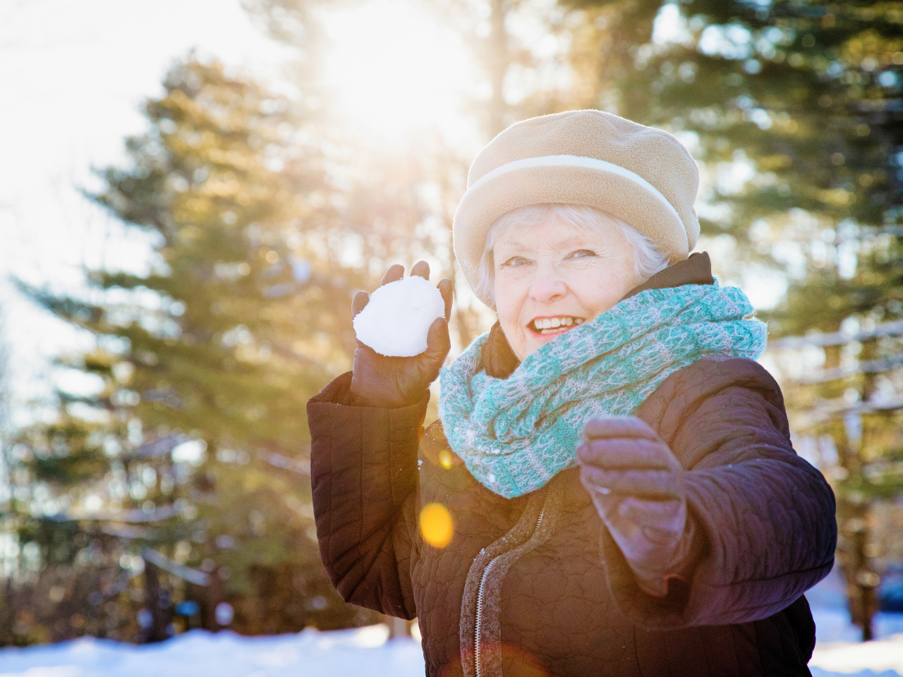 Woman holding a snowball ready to through it
