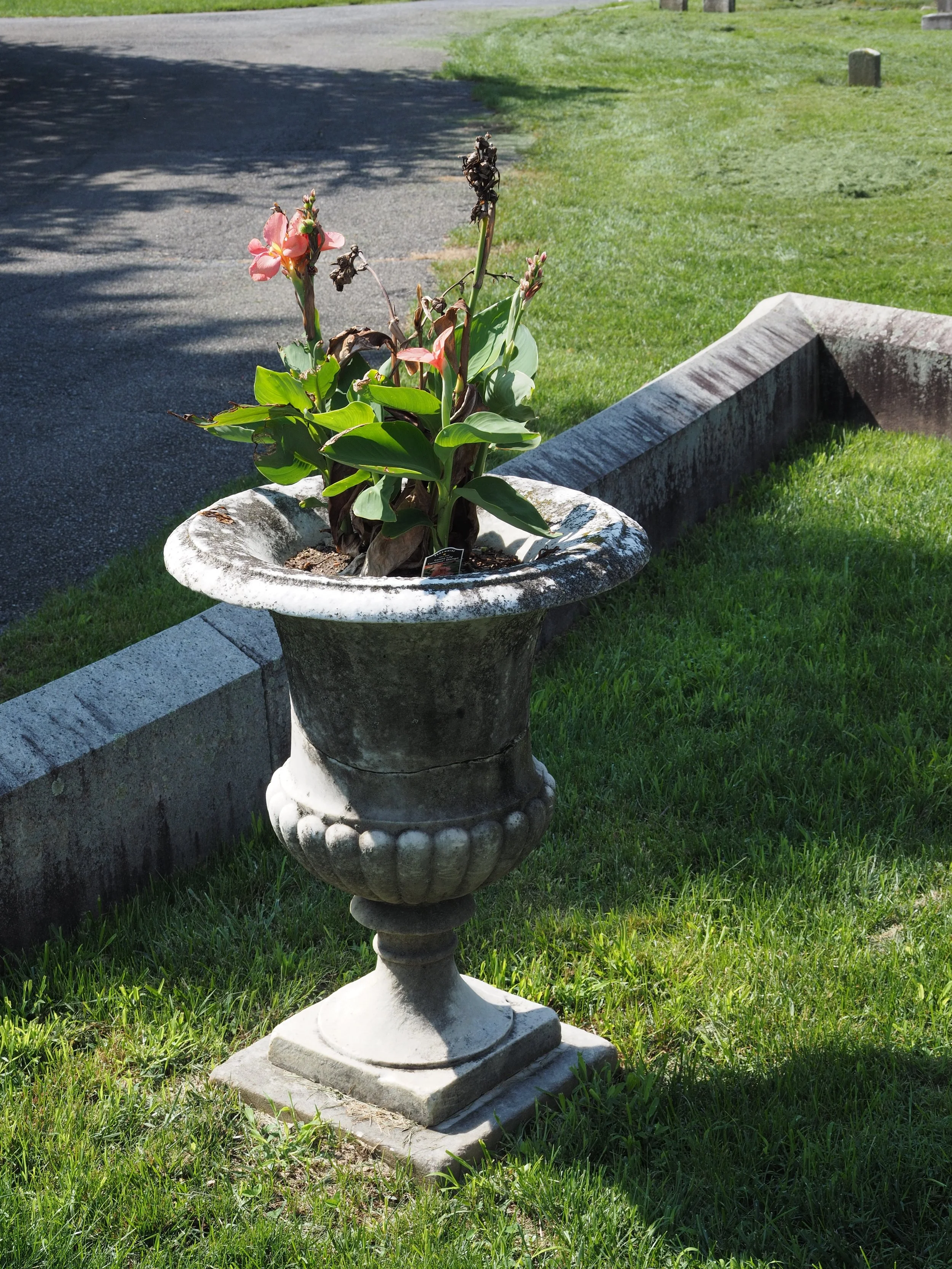Vases had base leveled on a tamped gravel bed, re-pin and reset as needed