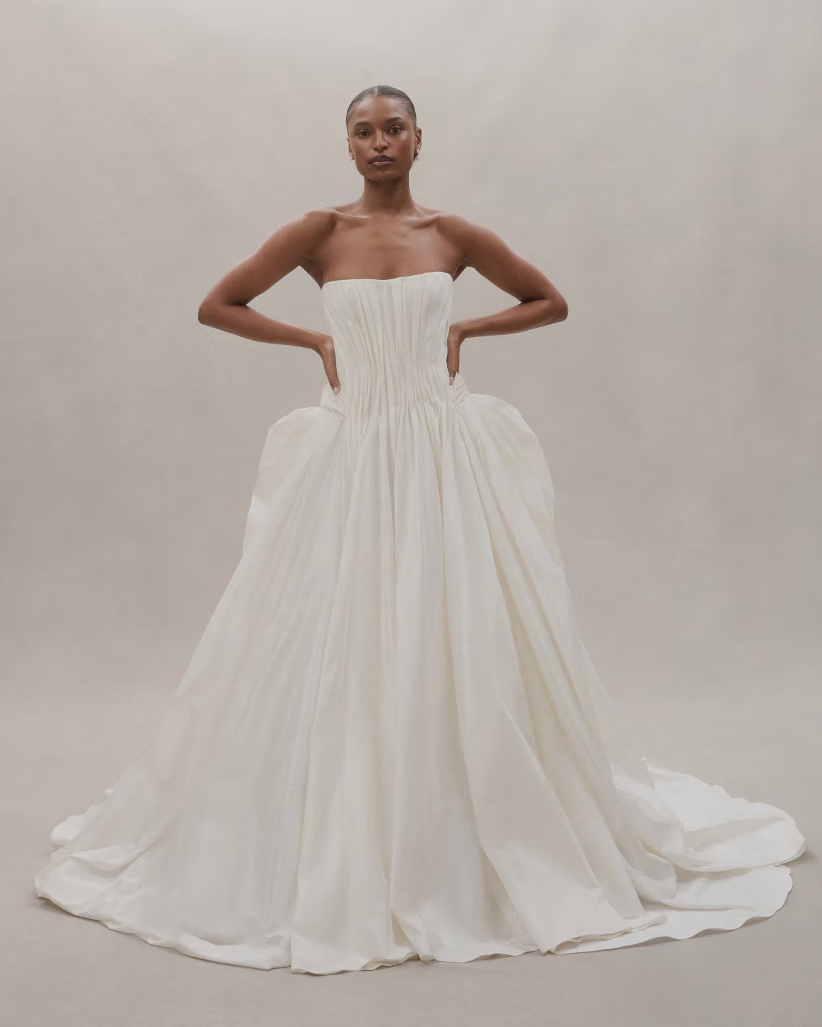   Alexandra Grecco  
 Designed and thoughtfully produced in NYC. Alexandra Grecco offers sophisticated gowns with luxurious fabrics and intricate hand-embroidered details. Her timeless yet modern silhouettes appeal to fashion-forward brides. 