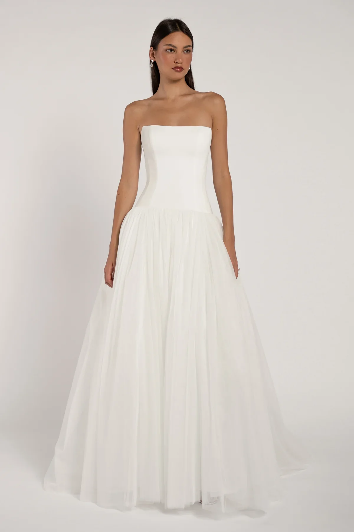 The Brooks gown is the perfect balance of modernity and whimsy. Her clean strapless bodice is met with a fanciful tulle skirt for a look that is effortlessly chic.