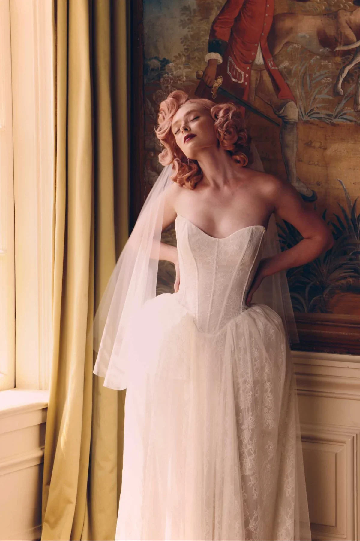 Carrington has a body flattering, fitted corset style bodice with Basque waist. It is an all over Chantilly lace gown to keep it airy, but totally romantic. Panniers at the hip are made from netting and horsehair banding for a historically inspired s