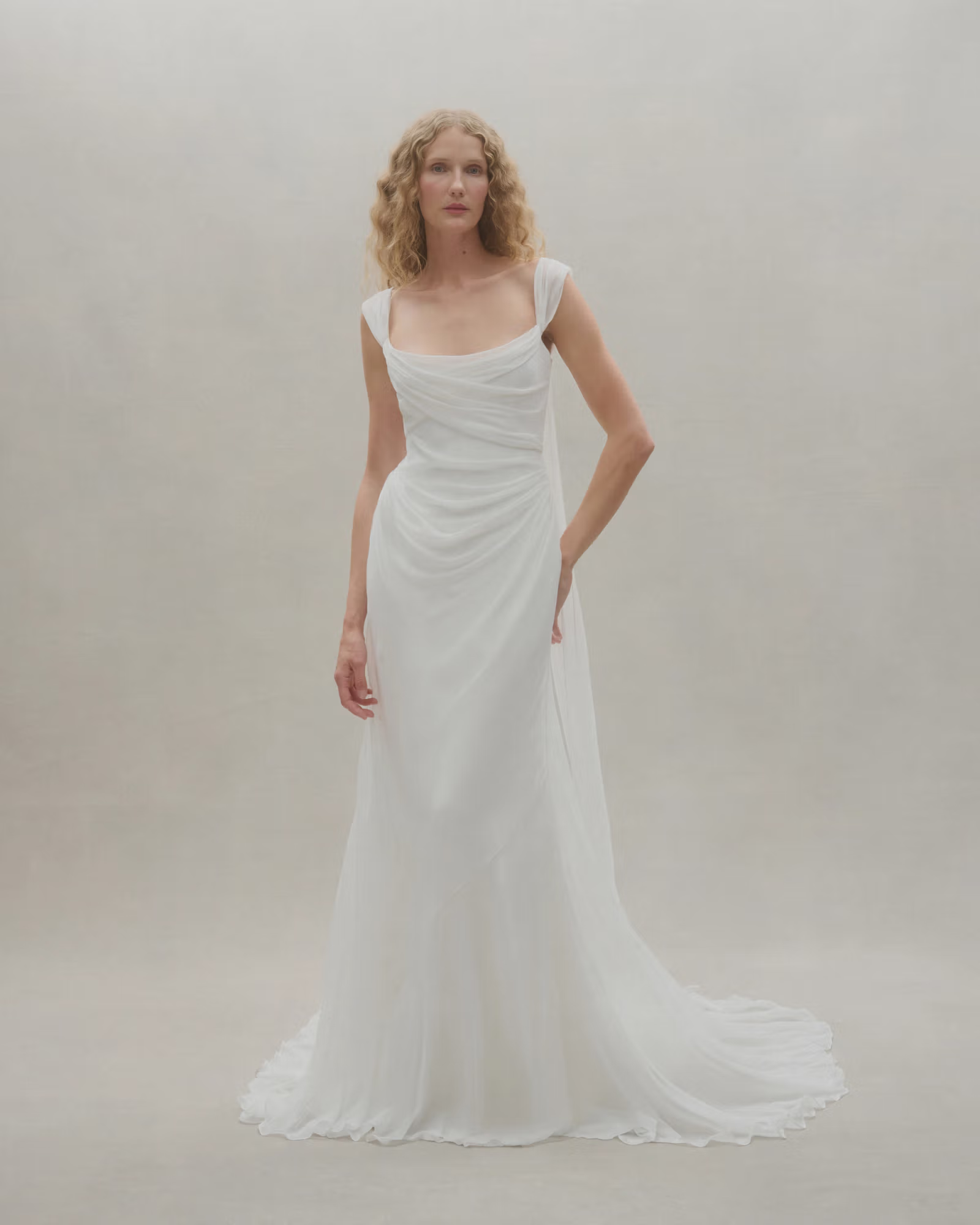 Isadora wedding gown featuring a structured bodice with soft silk chiffon draping, designed to be worn in multiple ways including cap sleeves, off-the-shoulder, halter, strapless, or spaghetti straps.