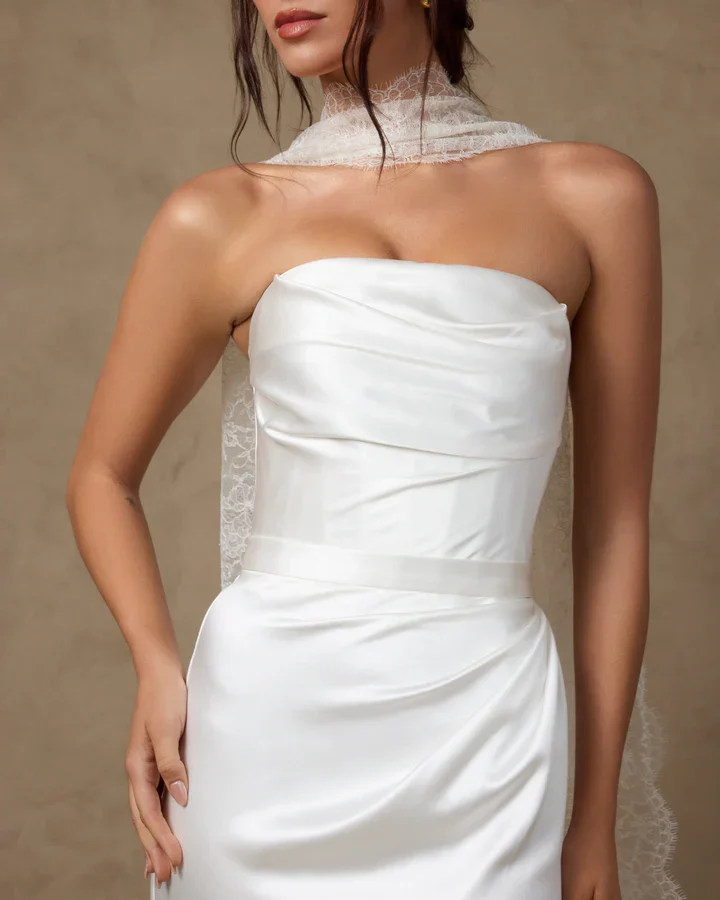 Harper wedding gown featuring luxurious satin silk crepe, a high curved neckline, a delicately hand-draped bodice, and a bias-cut silhouette that drapes effortlessly with soft, fluid movement.