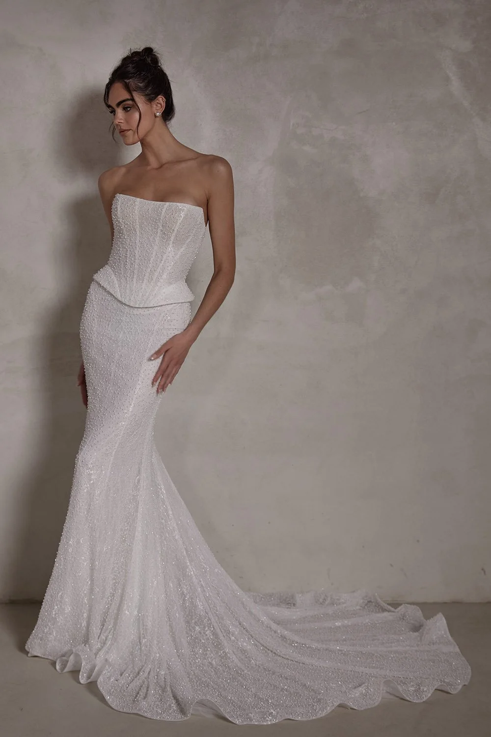 Celestine wedding gown featuring a pearl-encrusted Chantilly lace boned corset with built-in cups, a lace-up back, and a pearl tulle mermaid skirt with an elegant train and optional horsehair hem.