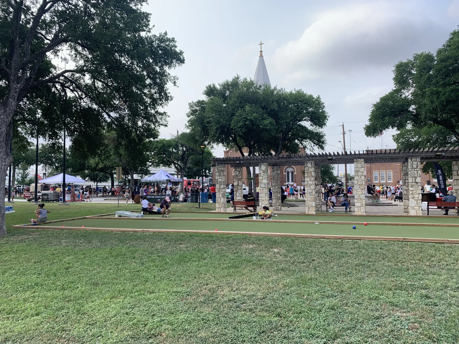 A festival on the lawn of Piazza Italia beside the San Francesco di Paola church steeple