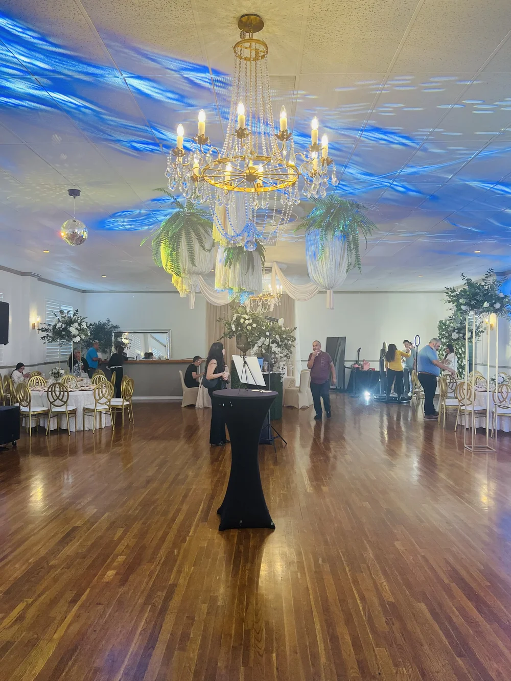 The Renaissance Room set for a reception, with gold chairs, a chandelier and a dance floor