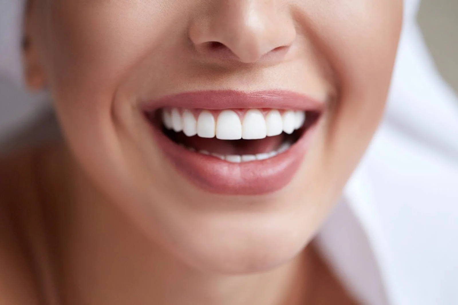 Close-up of a woman's broad smile showing clean, even white teeth