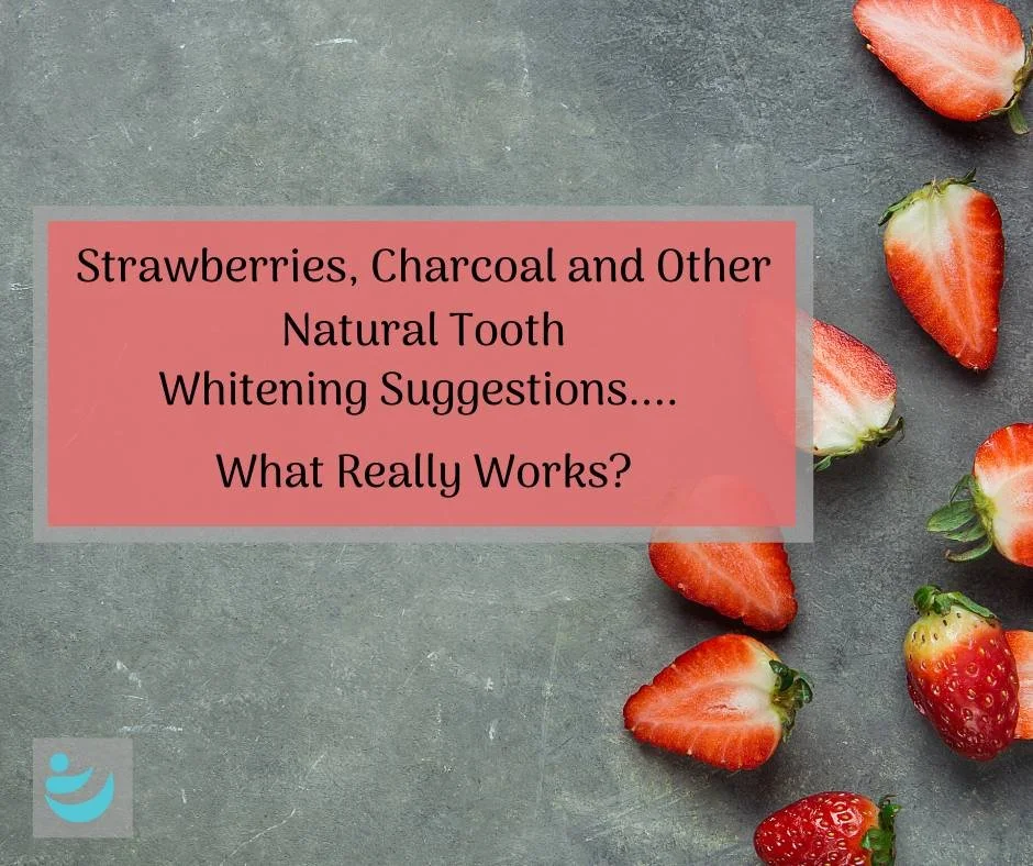 Strawberries on grey slate behind a red panel about natural tooth whitening