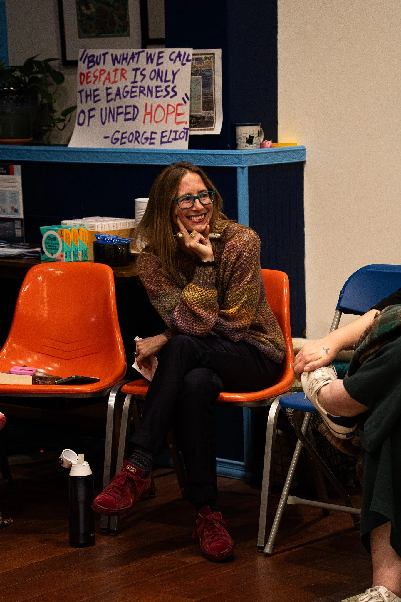 Elise Jajuga giggling over the comments a member of the book club was making over their book choice for the month during the November Book Club meeting on November 20th, 2025 in Lansing, Mich.