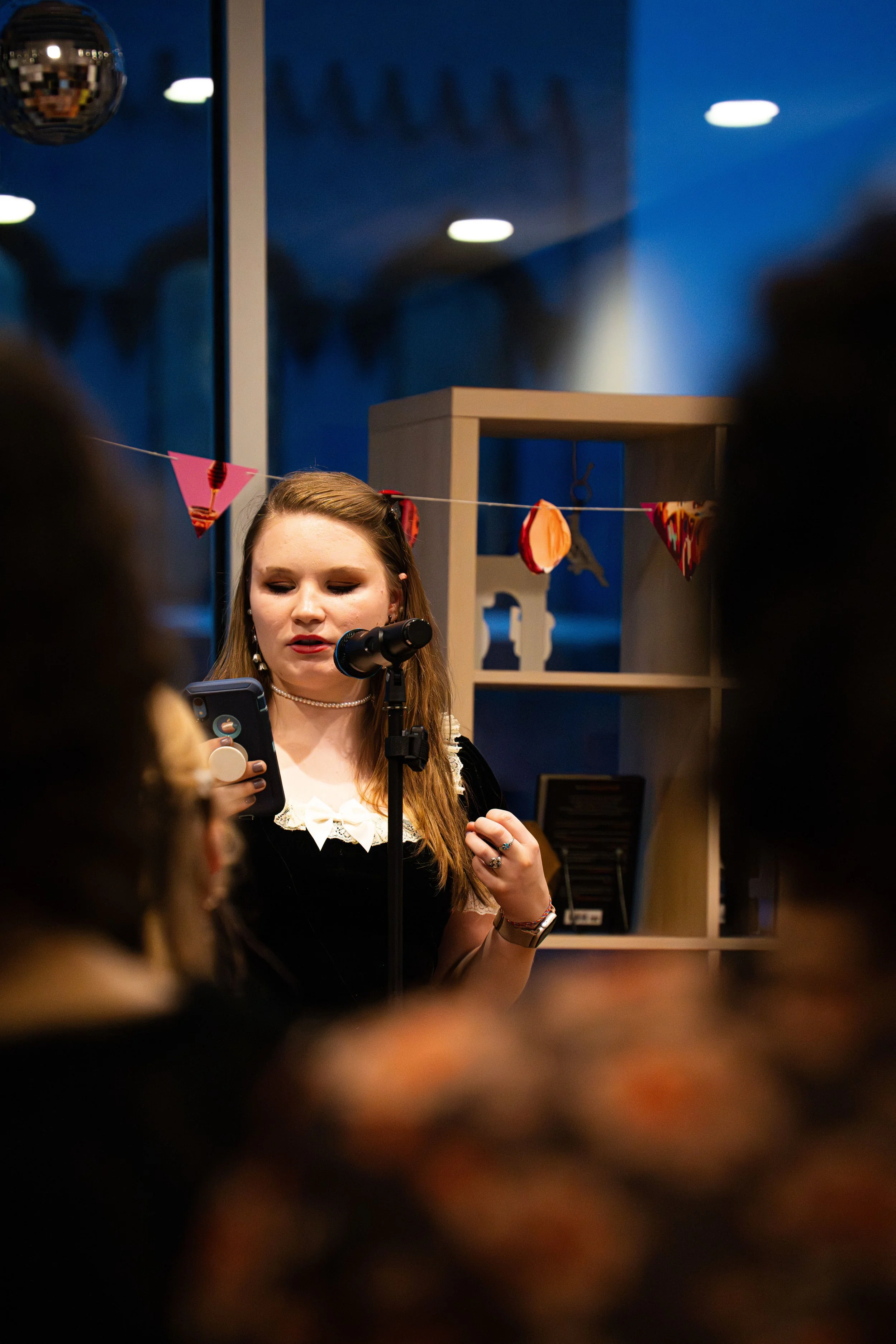 A member of the Poetry Room reading a new poem for the incredible audience at A Novel Concept's poetry slam with the Poetry Room on September 19th, 2025 in Lansing, Mich.