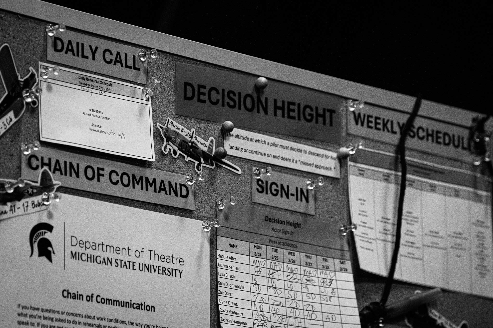 The Decision Height show corkboard that includes the attendance sign-in, the chain of command, the schedule for the week, call time for actors, and the quote of the show “The altitude at which a pilot must decide to descend for her landing or continu