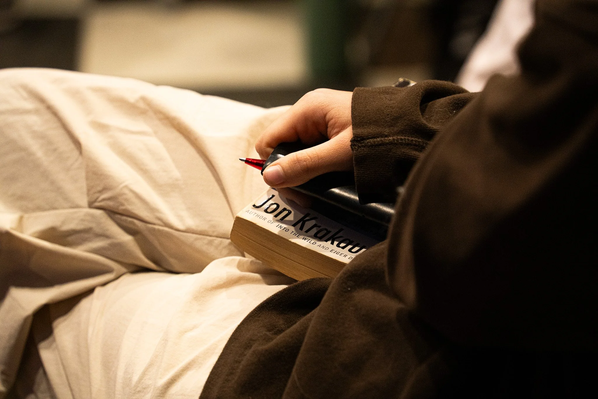 A member of the book club having a pen and notepad ready to take notes on the books discussed during the November Book Club meeting on November 20th, 2025 in Lansing, Mich.