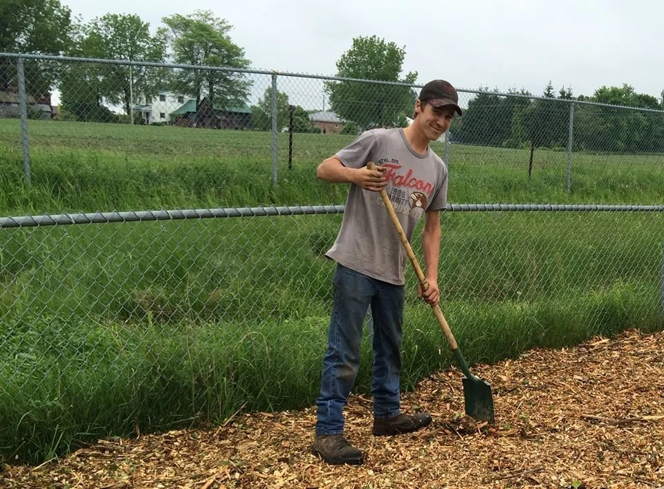 Volunteer shoveling dirt