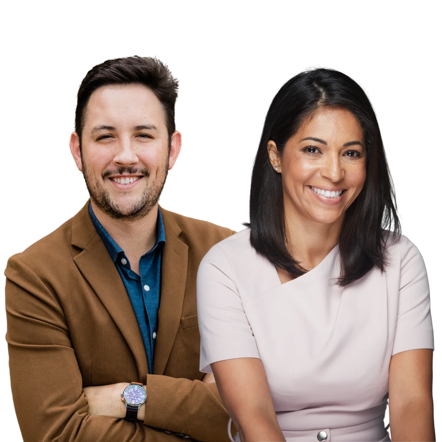 A smiling man and woman standing close together against a black background. The man has short dark hair, a beard, and is wearing a brown blazer over a blue shirt with a watch on his wrist. The woman has shoulder-length black hair, multiple earrings, and is wearing a light pink top. Both are facing the camera and smiling.