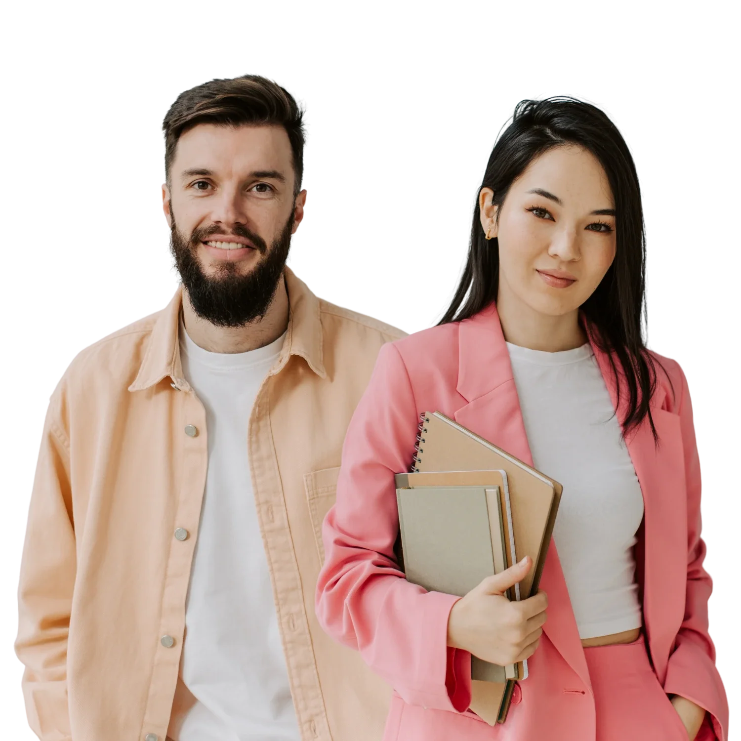 A man with a beard wearing a beige shirt and a woman with long dark hair wearing a pink blazer holding notebooks