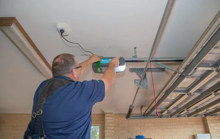 Paul from Lancaster Garage doors adjusting and testing a Merlin garage door opener to ensure correct spring balance and smooth motor operation.