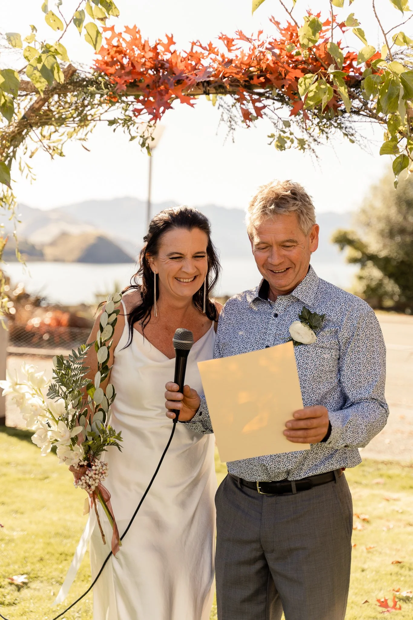 A bride and groom read their vows during their wedding ceremony.  