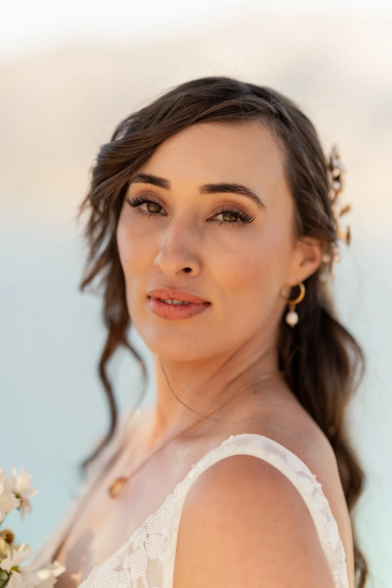 A bride standing in front of Lake Hāwea 
