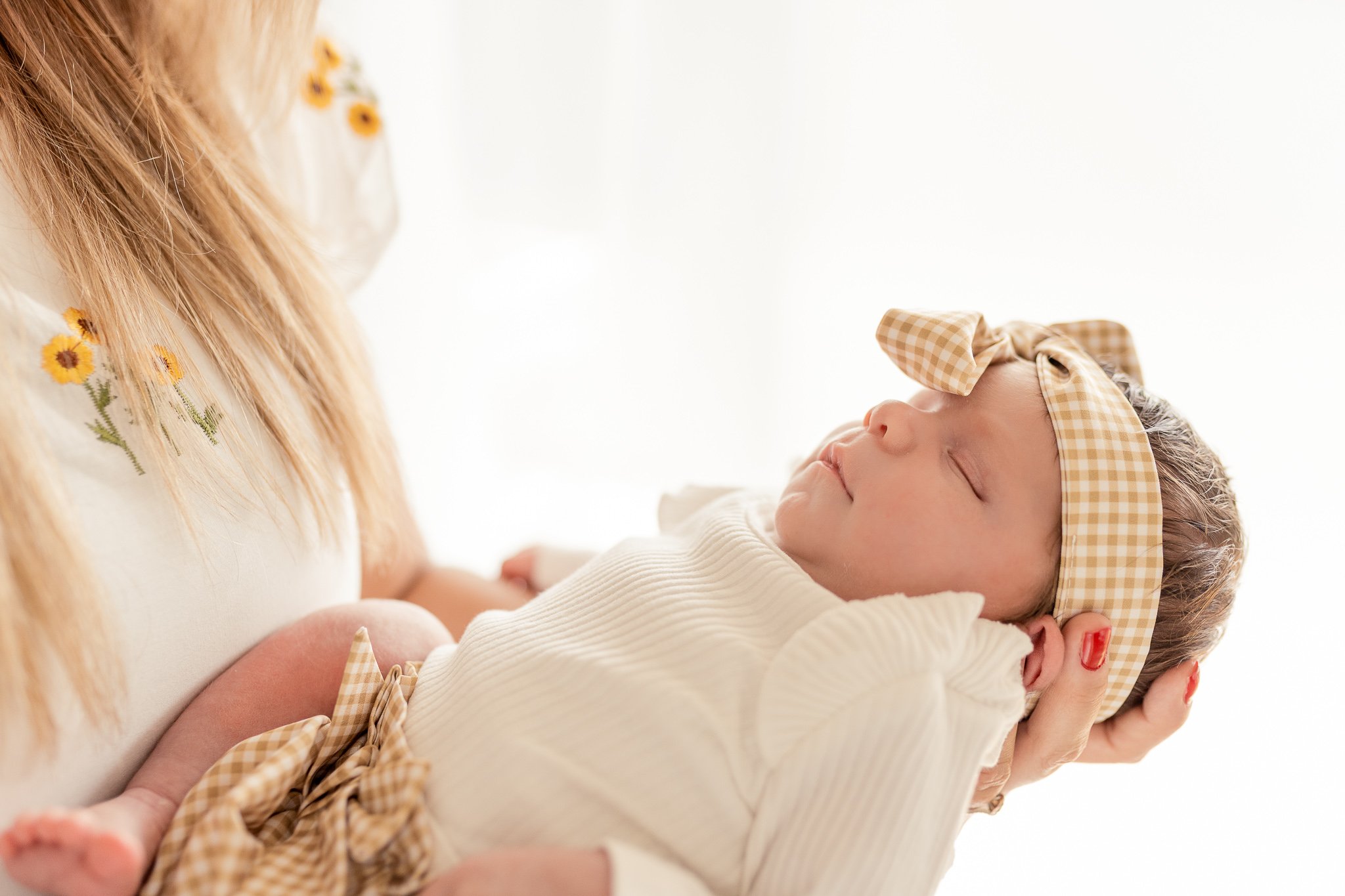 A close up of a woman holding her baby girl.